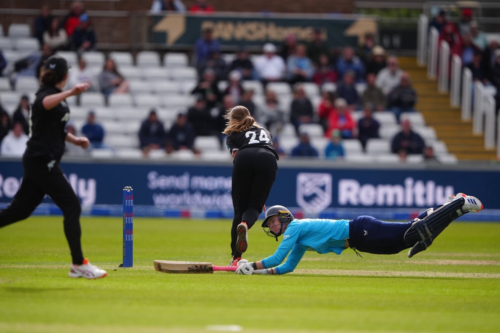 Freya Kemp dives back into the crease amid an attempted run-out (Owen Humphreys/PA) (PA Wire)