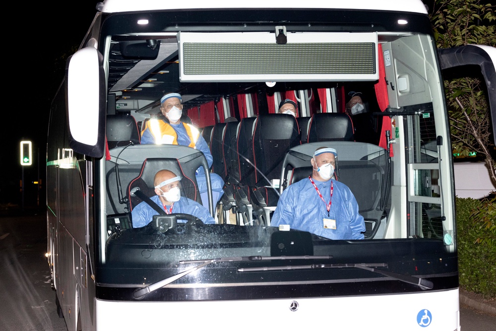 The bus carrying the British passengers and crew being repatriated from the MV Hondius makes its way to Arrowe Park Hospital (Getty)