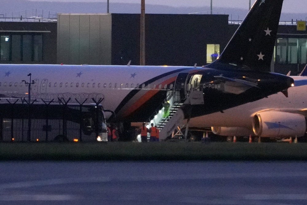 Passengers leaving a plane at Manchester Airport, after being repatriated to the UK from cruise ship MV Hondius, which was hit by hantavirus (PA)