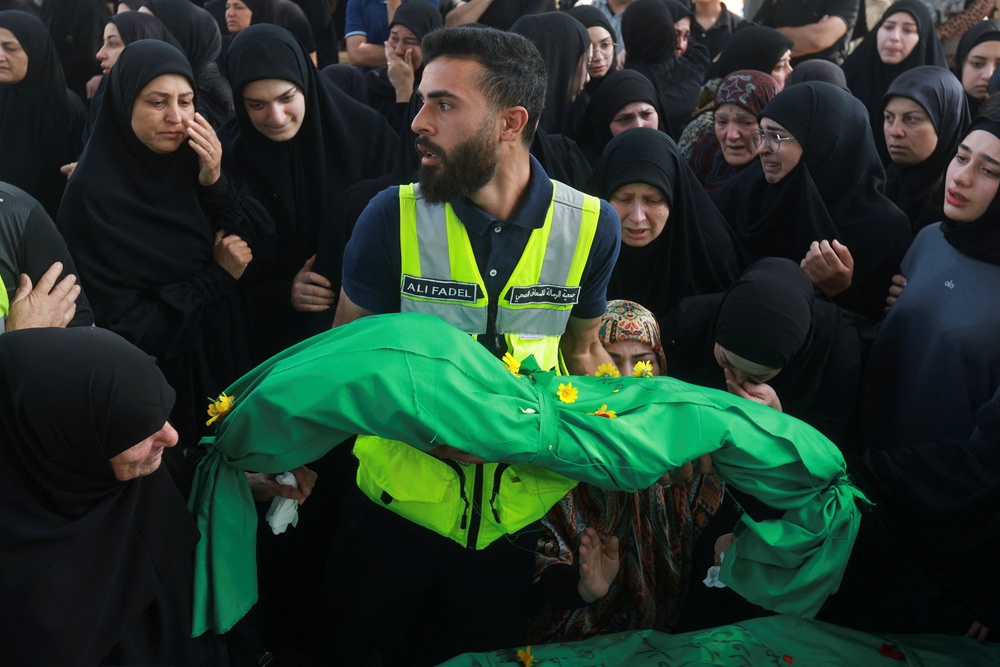 Funeral of people killed in an Israeli strike in Saksakiyeh, in Haret Saida (Reuters)