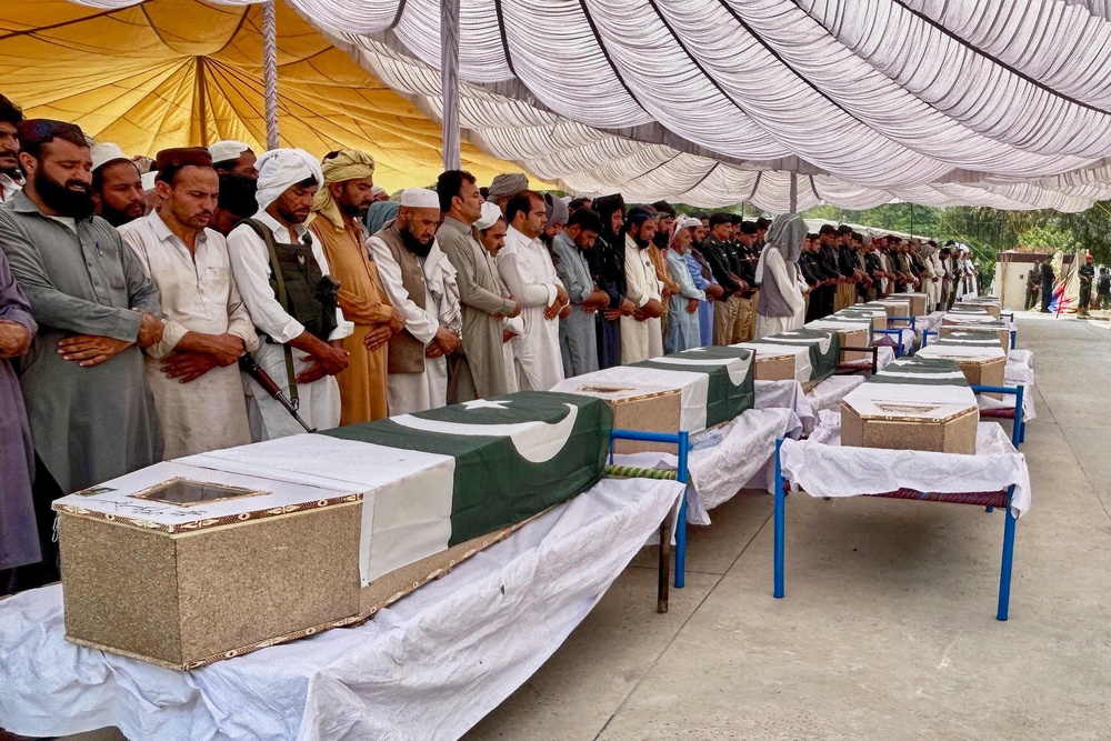 People offer funeral prayers for the police officers who were killed in the suicide bombing at a security post in Fatah Khel in Pakistan's Khyber Pakhtunkhwa province on 10 May 2026 (AP)