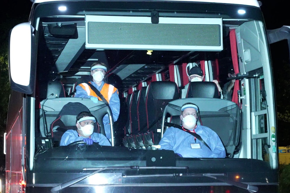 Coaches arriving at Arrowe Park Hospital on Merseyside (PA) (PA Wire)