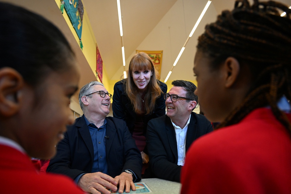 Prime Minister Sir Keir Starmer, Labour Party MP and former deputy prime minister Angela Rayner and Manchester Mayor Andy Burnham meet pupils during a visit to a school breakfast club (Paul Ellis/PA) (PA Wire)