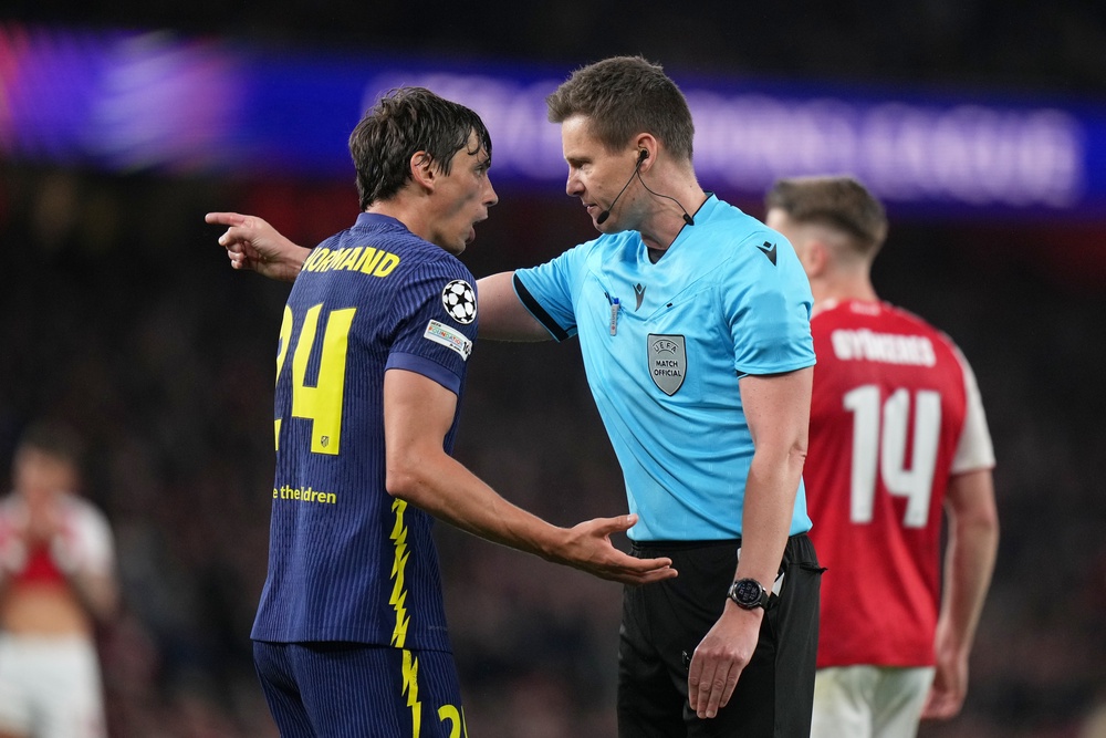 Atletico Madrid's Robin Le Normand speaks to Referee Daniel Siebert (AP)