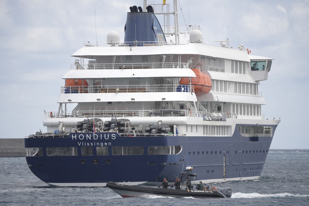 A Spain's Guardia Civil boat sails next to Dutch flagged hantavirus-stricken cruise ship MV Hondius in the port of Granadilla de Abona on the island of Tenerife in Spain's Canary Islands on 11 May 2026 (AFP/Getty)