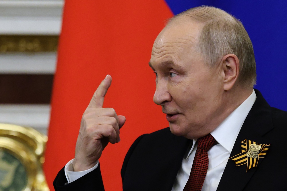 Russian president Vladimir Putin gestures at the Grand Kremlin Palace in Moscow (AP)