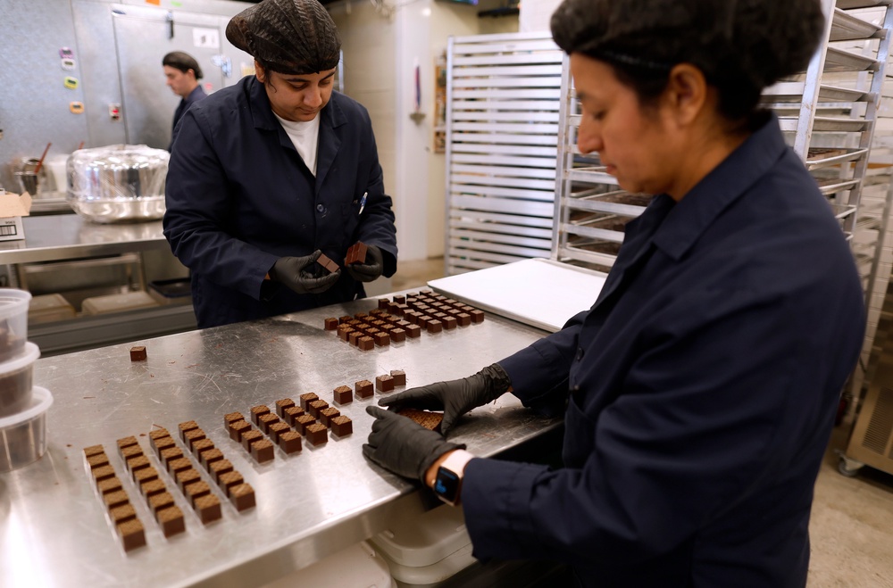 Workers arrange freshly made chocolate truffles at the Dandelion Chocolate 16th Street Factory in San Francisco, California, last May. Dark chocolate is rich in antioxidants that fight harmful inflammation (Getty)