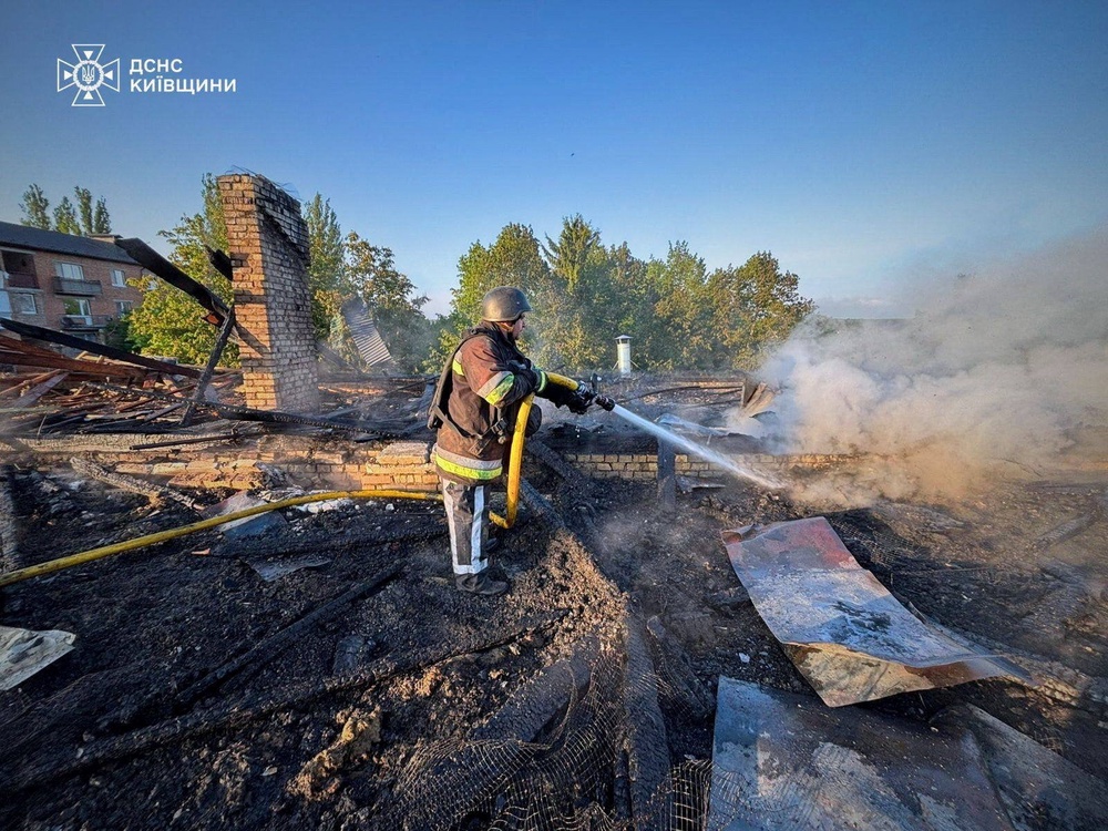 A firefighter works at the site of a kindergarten damaged during a Russian drone strike in Kyiv (Reuters)