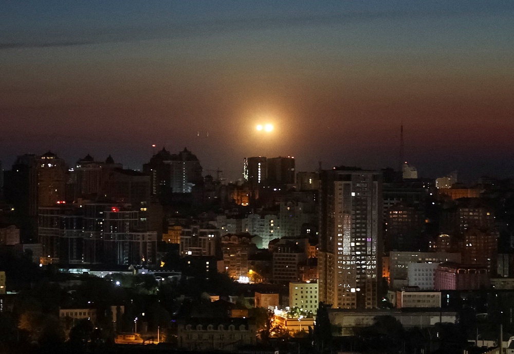 Explosions over the city as Ukrainian servicemen hit a Russian drone during a Russian drone strike in Kyiv (Reuters)