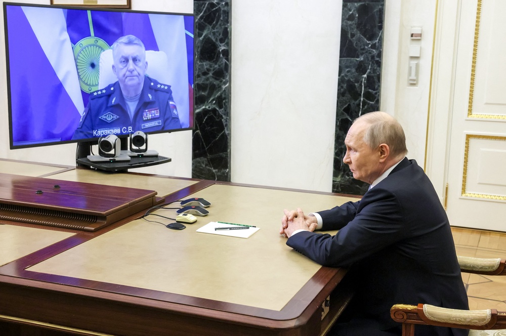 In this pool photograph distributed by the Russian state agency Sputnik, Russia's President Vladimir Putin holds a videolinked meeting with the country's missile forces commander, Sergei Karakayev (AFP/Getty)