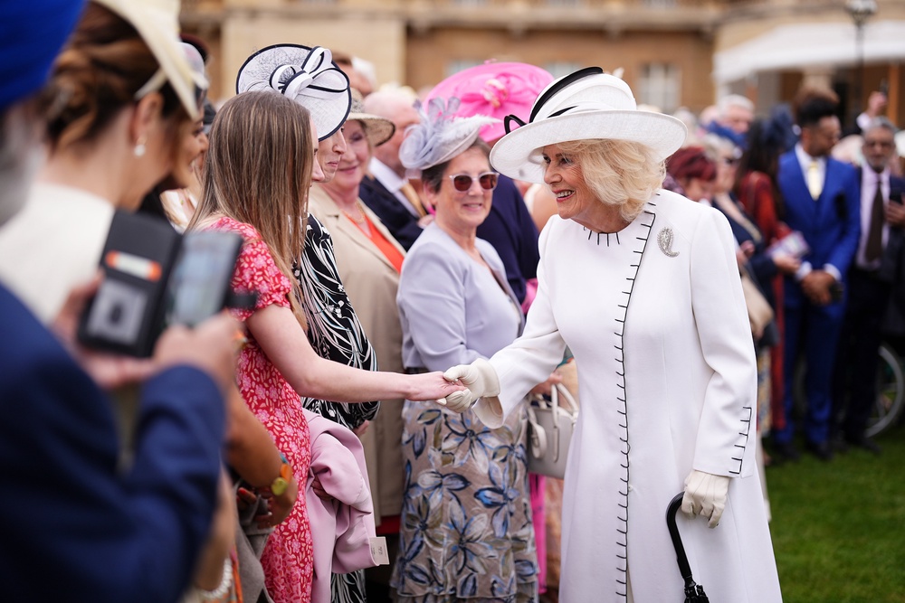 Camilla wore a white crepe dress and a white wool coat by Anna Valentine (Aaron Chown/PA) (PA Wire)