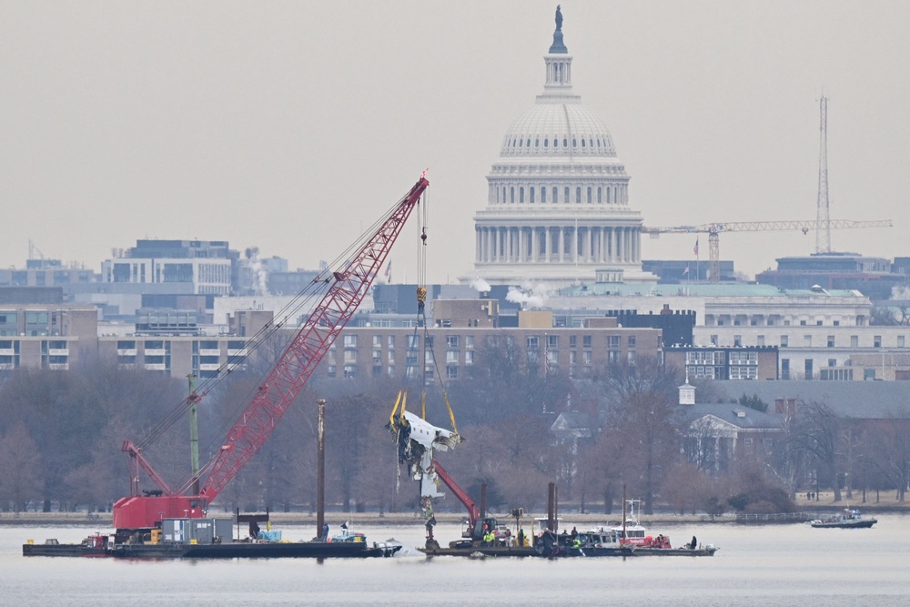 The US Capitol is seen in the background as a crane removes wreckage from the Potomac River in Washington, on Feb. 3, 2025, following the deadly midair collision of a passenger plane and a military helicopter (AFP/Getty)