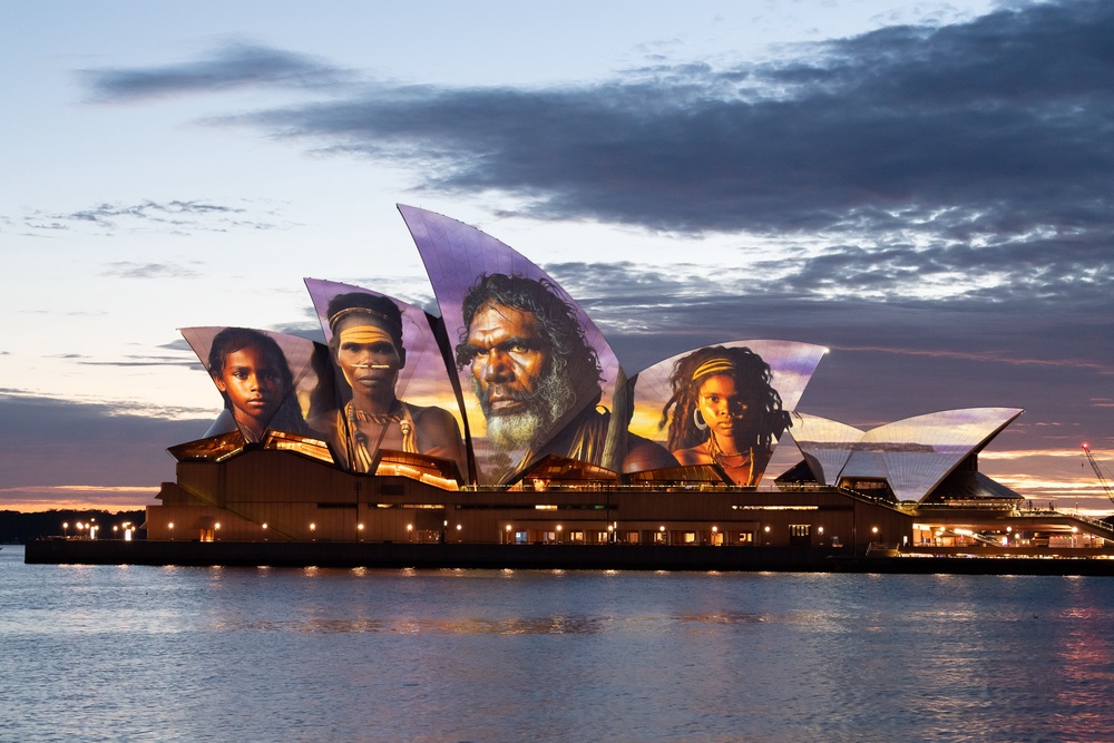 The sails of the Sydney Opera House are illuminated by a projection of indigenous artwork by Indigenous artist Brett Leavy (Getty)