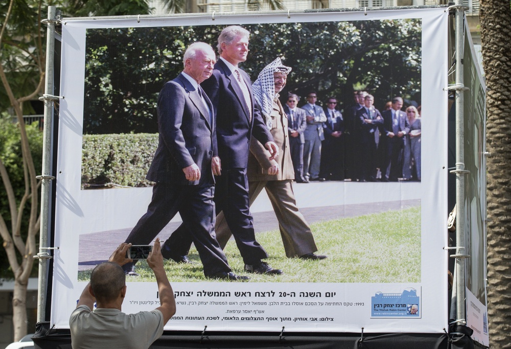 A photograph showing Yitzhak Rabin (left) walking alongside former US president Bill Clinton and Yasser Arafat in 1993 (AFP/Getty)