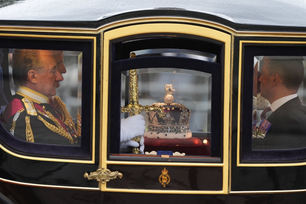 Officials in Queen Alexandra’s State Coach carry the Imperial State Crown (Ben Whitley/PA) (PA Wire)