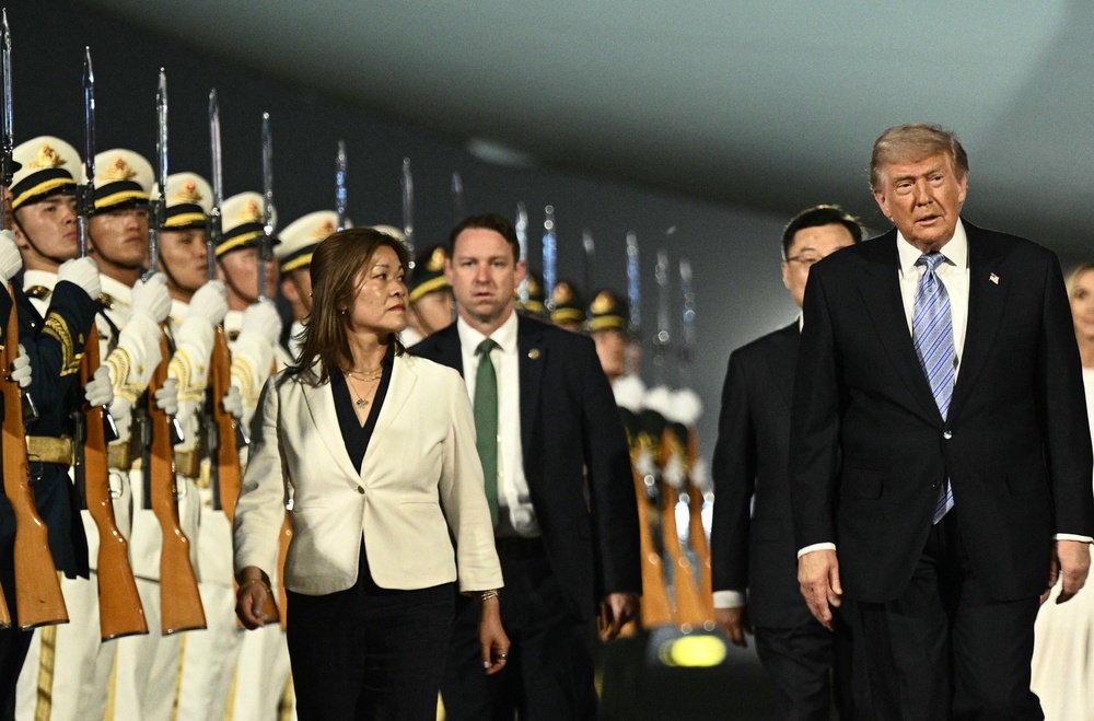 Donald Trump walks off Air Force One as he arrives at Beijing Capital Airport in Beijing (AFP/Getty)