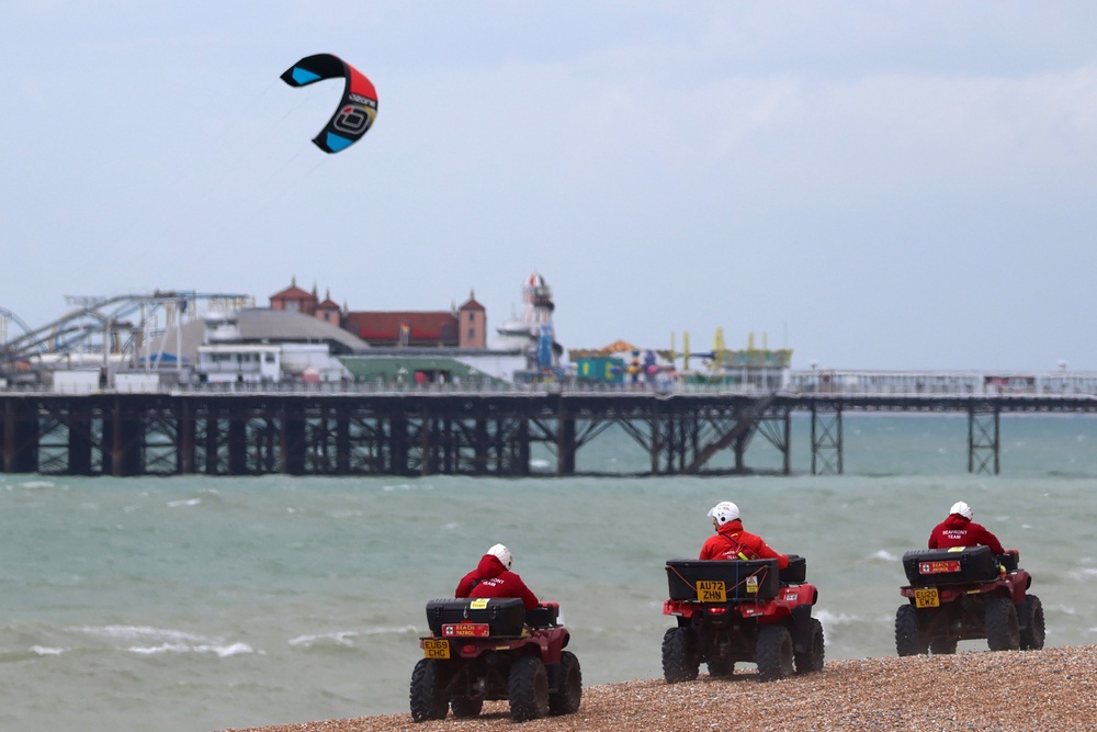 Beach Patrol vehicles drive along the beach after the bodies of three women were recovered from the sea (Getty)