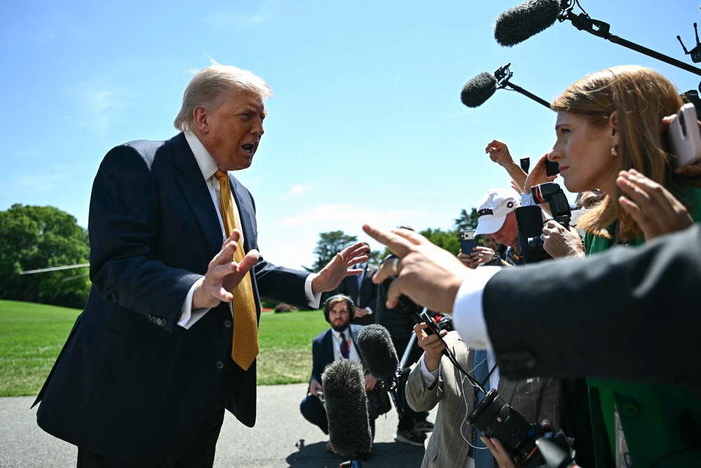 Trump speaks to reporters outside the White House in Washington and said, ‘I don't think about Americans' financial situation’ (AFP/Getty)