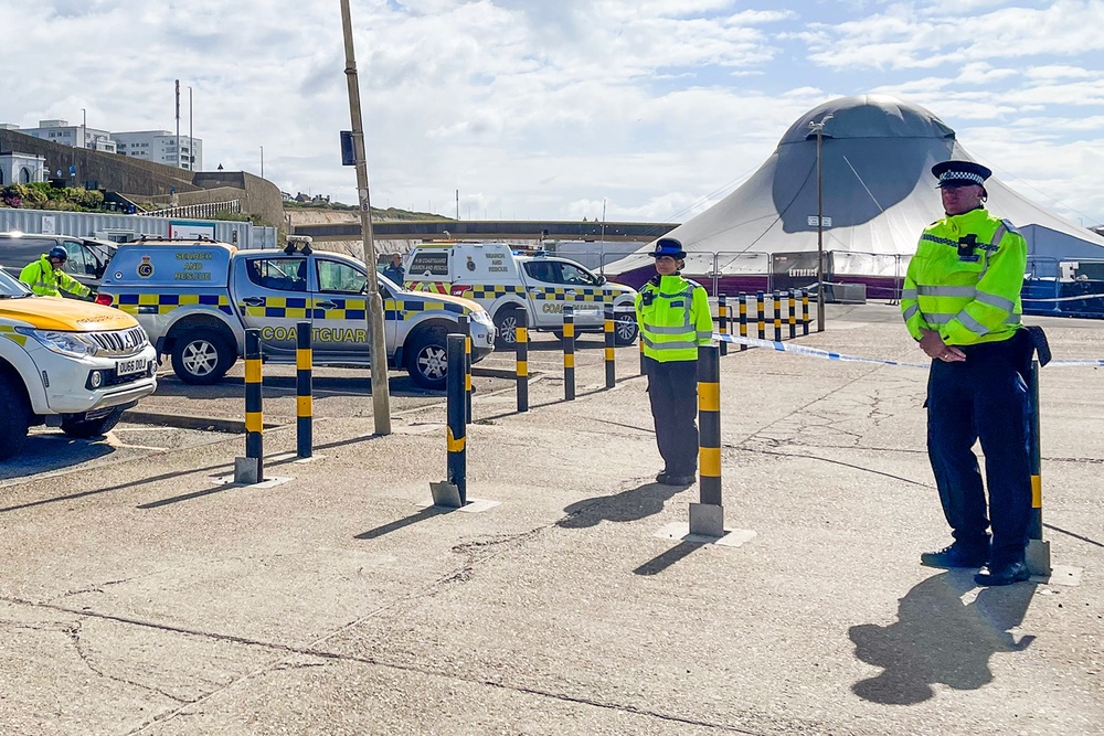 Police guard a scene near Brighton Beach (PA)