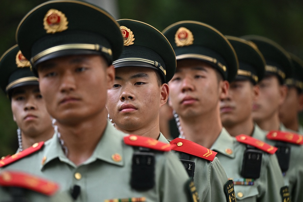 Chinese paramilitary police officers are seen around the perimeter of the hotel where US President Donald Trump is staying in Beijing (AFP/Getty)