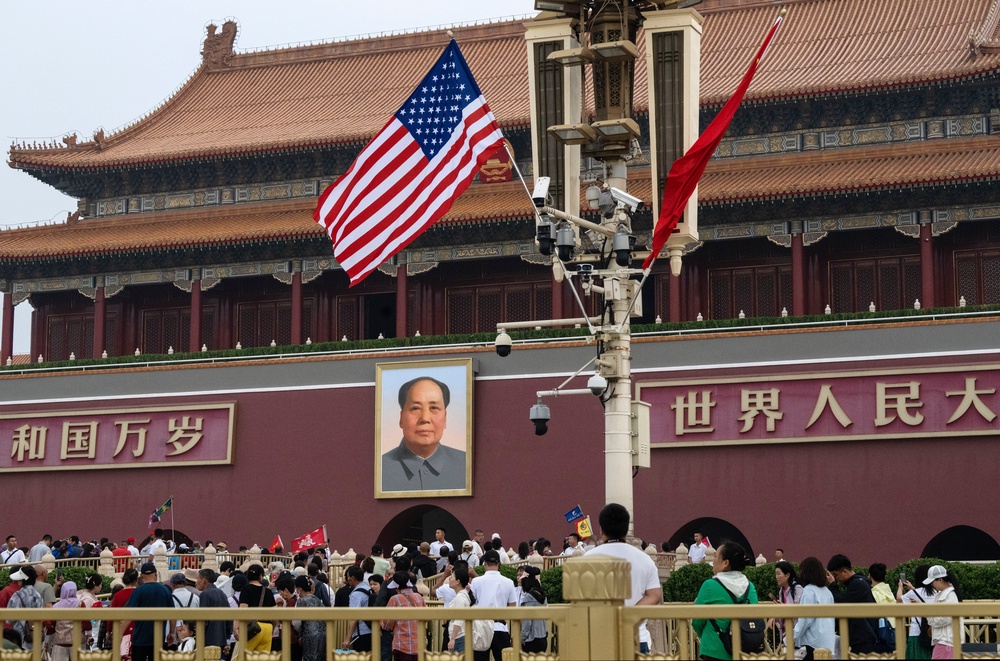 An American flag flies near a portrait of the late Mao Zedong at Tiananmen Gate (Getty)