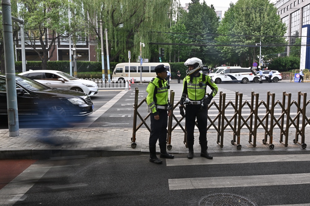 Chinese police officers are seen around the perimeter of the hotel where US President Donald Trump is staying in Beijing (AFP/Getty)
