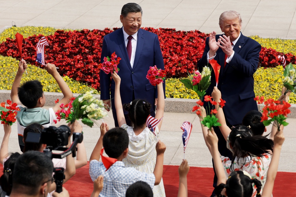 Xi Jinping and Donald Trump are entertained by schoolchildren at the Great Hall of the People in Beijing (Getty)