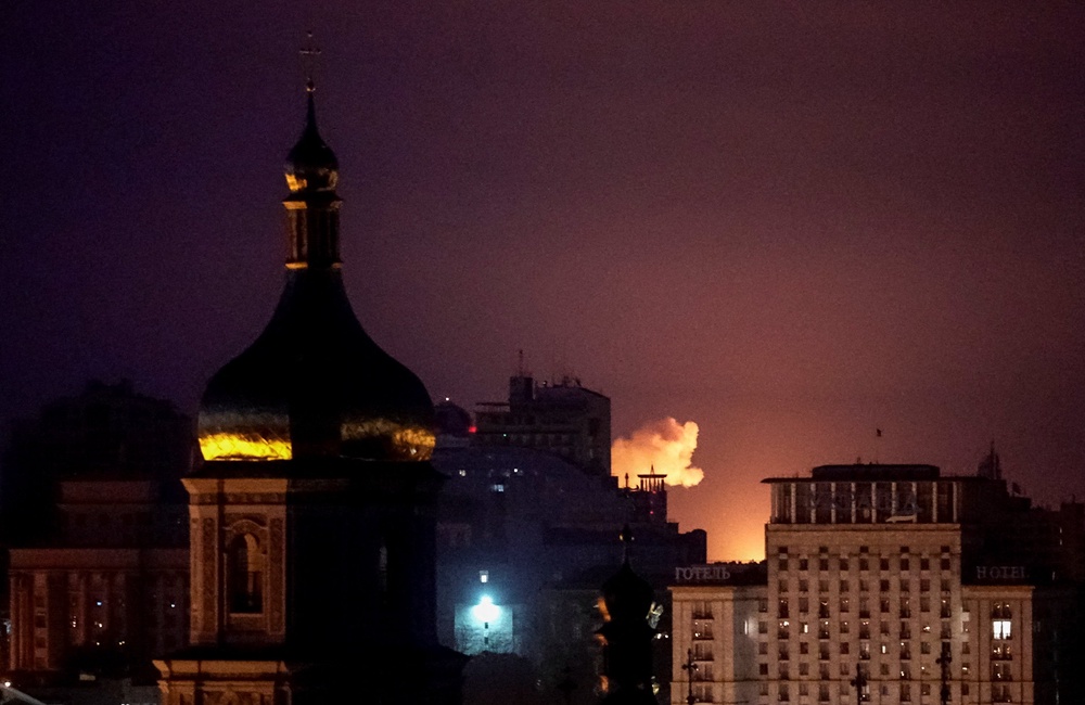 An explosion lights up the sky over the city during a Russian missile and drone strike in Kyiv (Reuters)