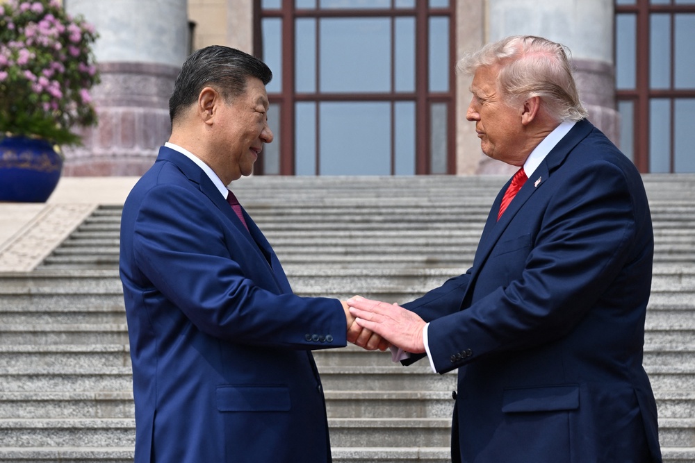 US President Donald Trump (R) shakes hands with China's President Xi Jinping at the Great Hall of the People in Beijing (AFP/Getty)