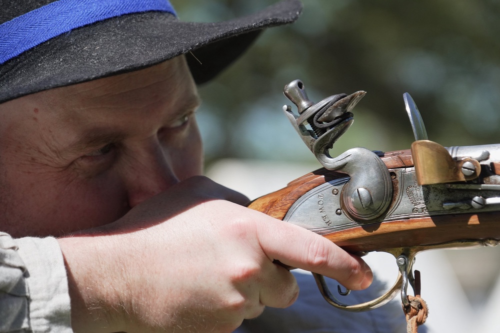 A.J. Drake, a historic interpreter, aims his Brown Bess flintlock replica musket during a Revolutionary War event in Halifax, N.C., on April 10, 2026. (AP Photo/Allen G. Breed) (Copyright 2026 The Associated Press. All rights reserved)