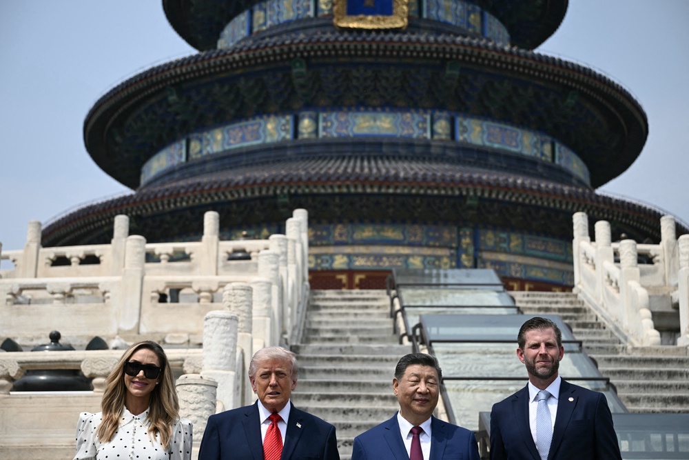 China's President Xi Jinping (2nd R) and US President Donald Trump (2nd L) pose for a photo with Eric Trump (R) and his spouse Lara Trump at the Temple of Heaven in Beijing (Reuters)