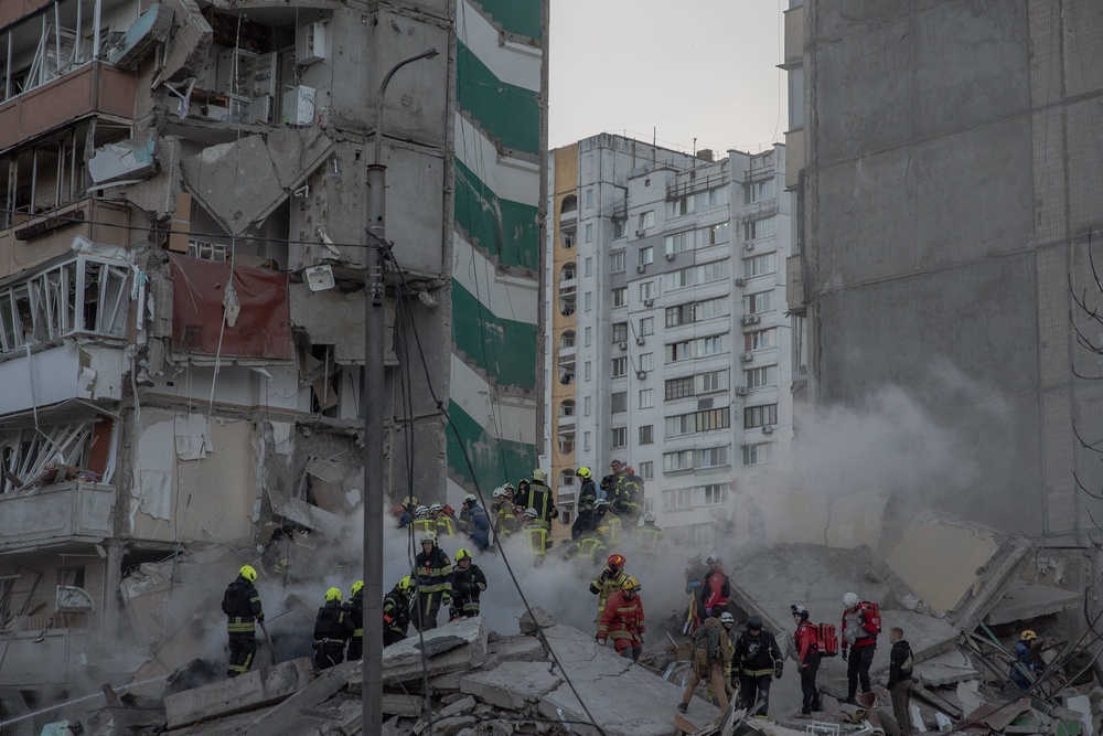 Rescuers work at a residential building partially destroyed in Kyiv after overnight attacks (AFP/Getty)