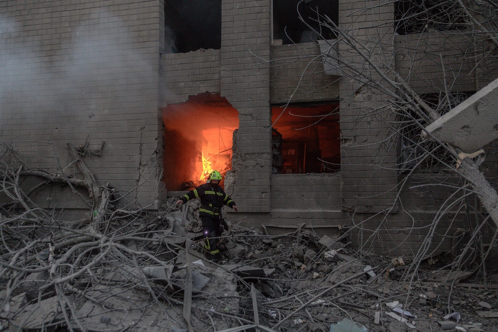 A rescuer works next to a heavily damaged building following Russian drone and missile strikes in Kyiv (AFP/Getty)