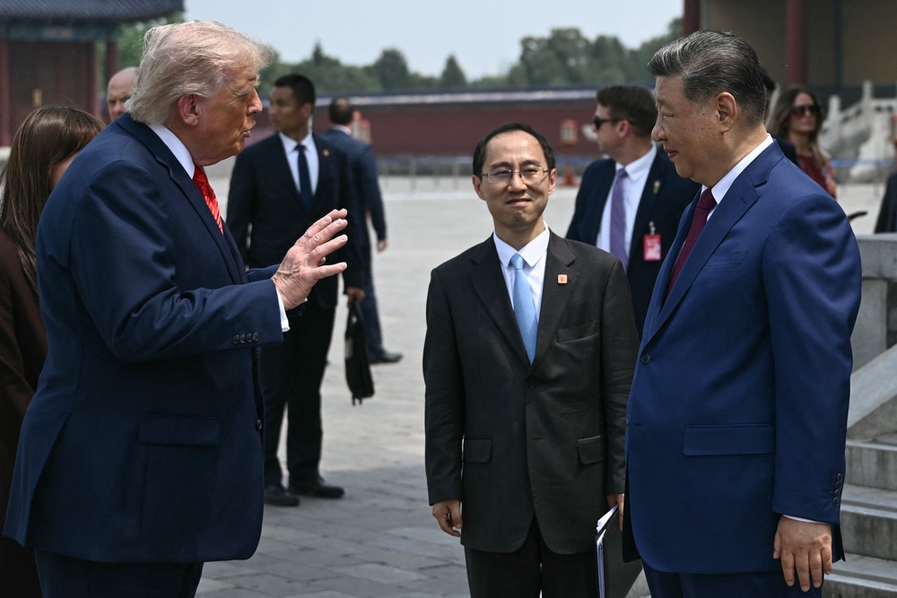 China's President Xi Jinping (R) and US President Donald Trump talk during their visit to the Temple of Heaven in Beijing (AFP/Getty)