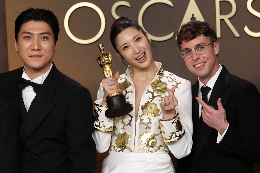 Jeong Hoon Seo, Ejae, and Mark Sonnenblick with the Oscar for Best Music for 'Golden' from KPop Demon Hunters (AFP via Getty)
