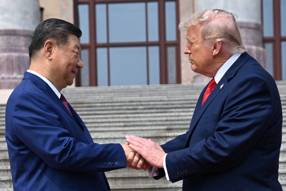 Chinese President Xi Jinping, left, shakes hands with U.S. President Donald Trump at the Great Hall of the People (AP)