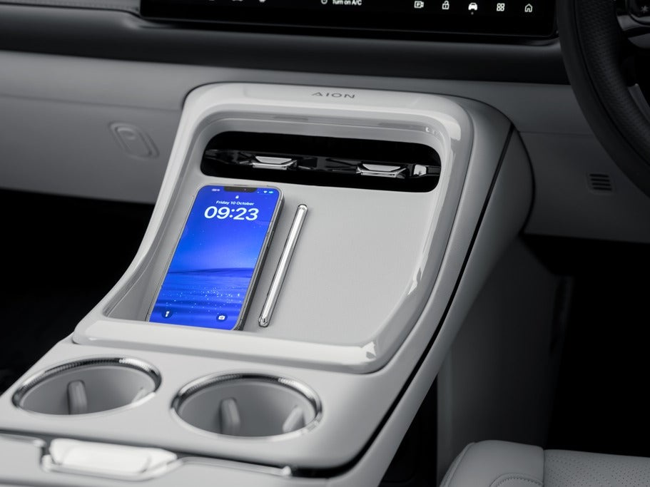 The big-quality interior of the Aion V features a cooled 50W wireless charging pad for a mobile phone (Aion)