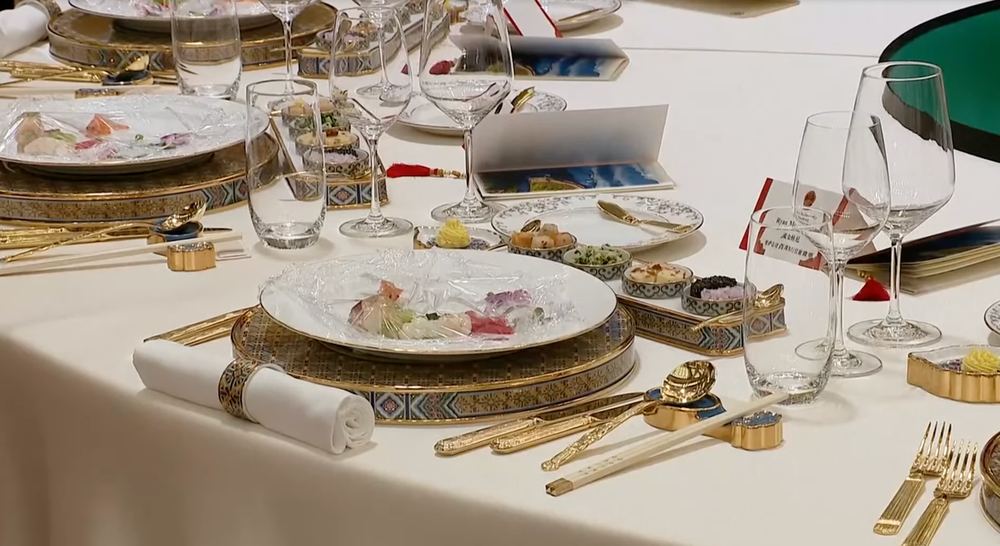 Tables were seen set with gilded silverware and wine glasses (The Independent)