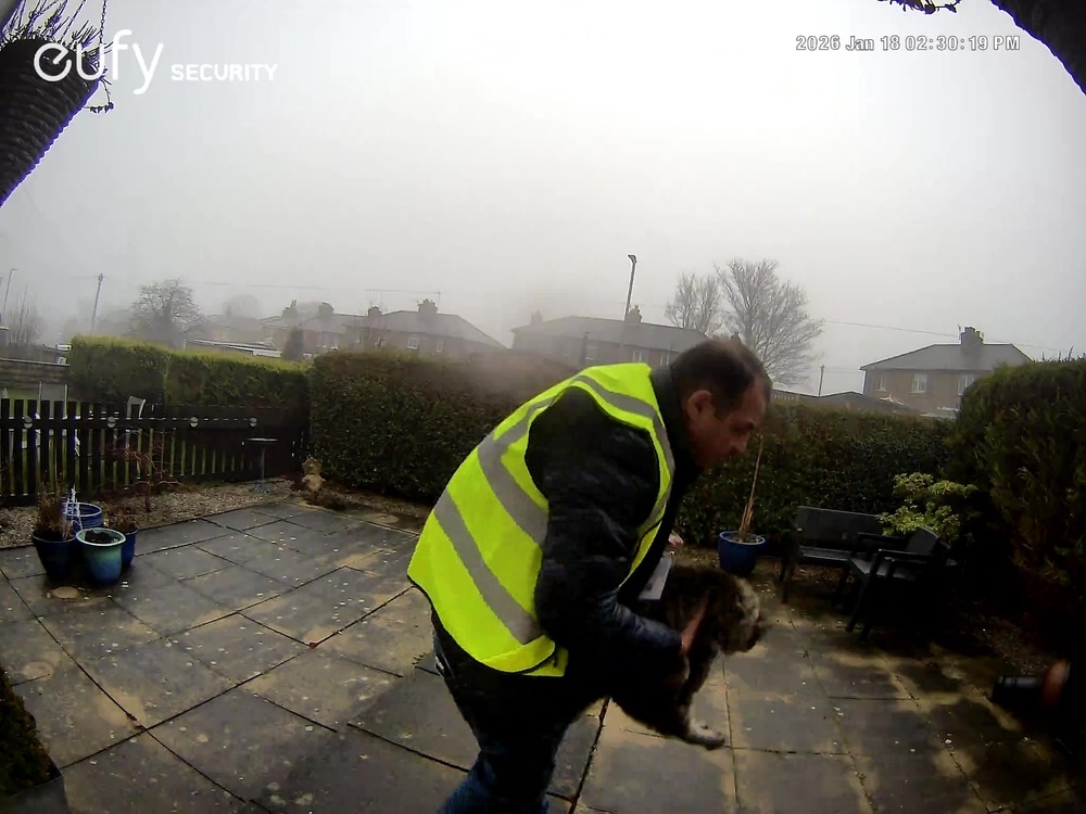 Screengrab taken from doorbell camera footage of Amazon delivery driver Catalin Stancu taking cat Nora (PA)