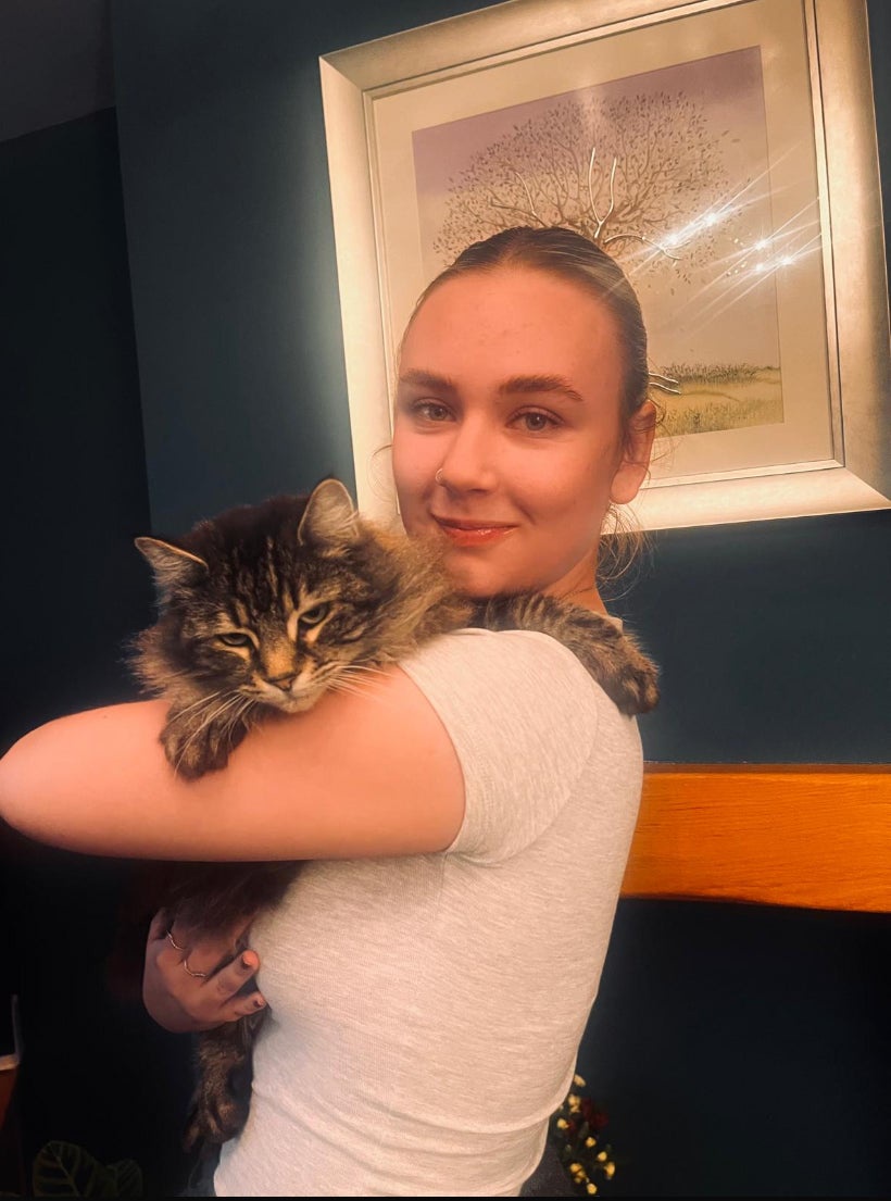 Kyla Sharpe with her cat Nora (PA)