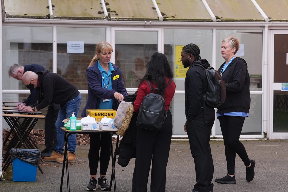 People queuing to receive vaccines and antibiotics at the University of Kent campus in Canterbury in March (PA)
