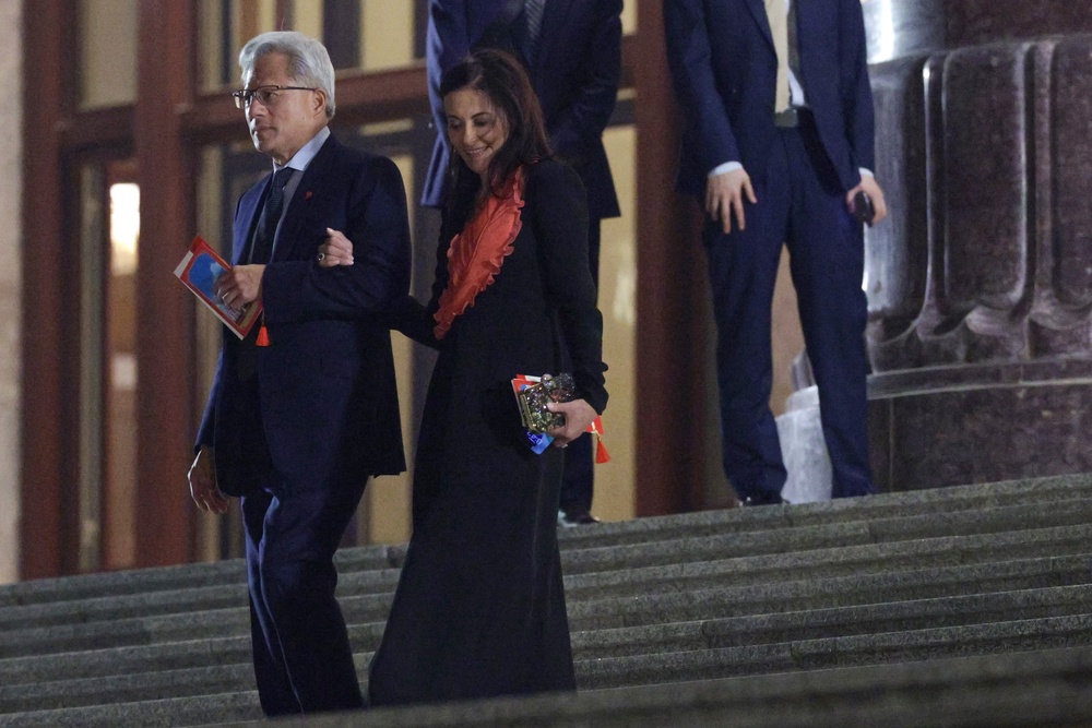 CEO of Nvidia Jensen Huang and Meta President and Vice Chairman Dina Powell McCormick depart a state banquet hosted by Chinese President Xi Jinping at the Great Hall of the People (Getty)