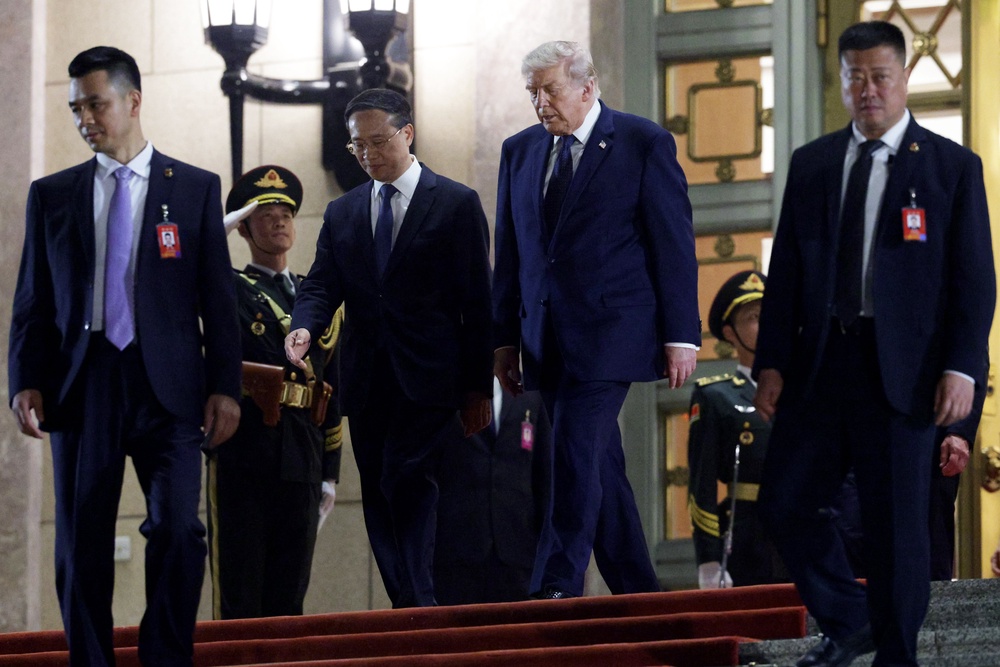 U.S. President Donald Trump, flanked by Chinese Executive Vice Minister of Foreign Affairs Ma Zhaoxu, departs a state banquet hosted by Chinese President Xi Jinping at the Great Hall of the People (Getty)