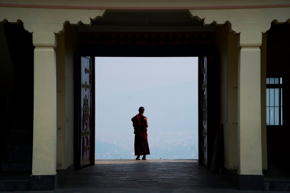 A Buddhist monk takes a break from a ritual at Dzarong Thubten Mindrol Dongä Monastery in Kathmandu, Nepal (Copyright 2026 The Associated Press. All rights reserved.)