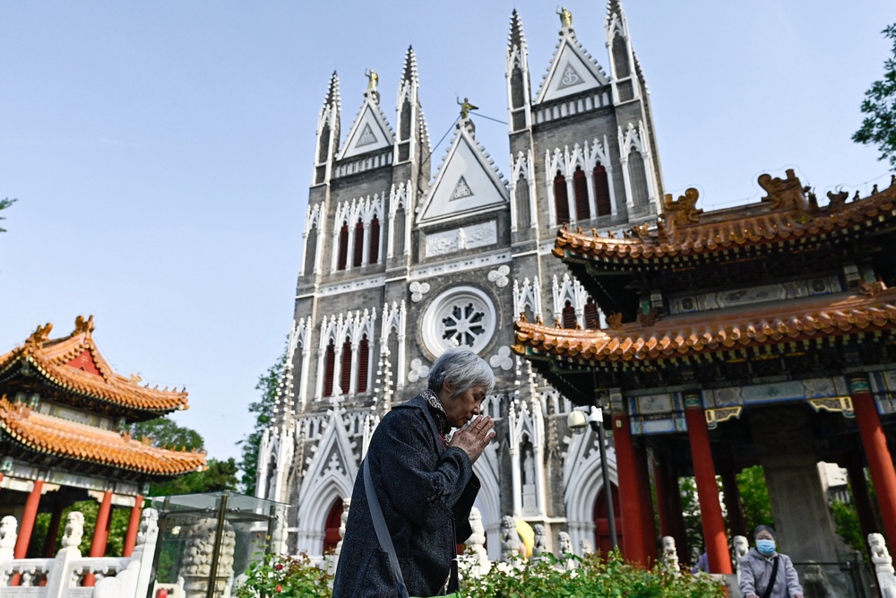 A woman prays at the Xishiku Catholic Church in Beijing on April 26, 2025 (AFP/Getty)