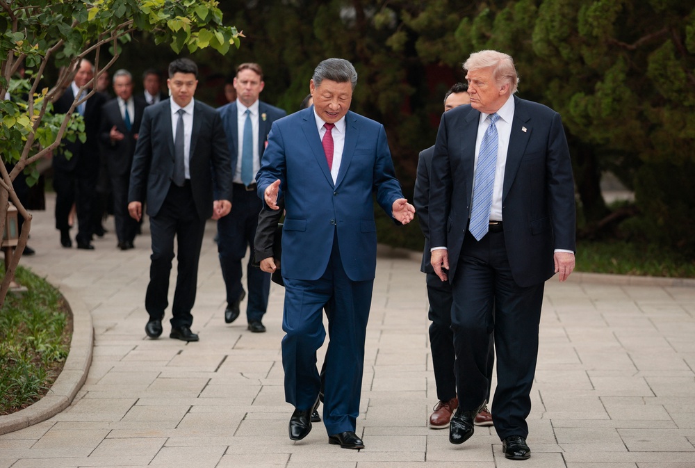 US President Donald Trump (R) walks with China's President Xi Jinping (C) as he leaves after a visit to Zhongnanhai Garden in Beijing (AFP/Getty)