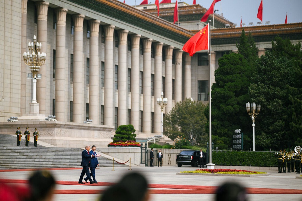 Trump and Xi pictured walking outside the Great Hall of the People in Beijing earlier this week (Truth Social, @realDonaldTrump)