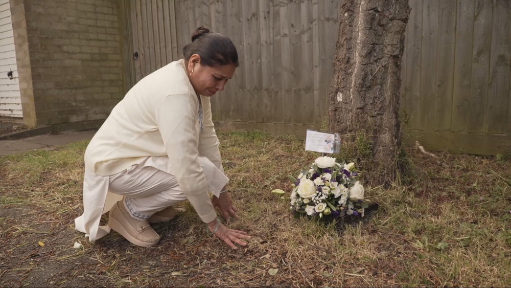 Harshita Brella's mother Sudesh Kumari laying flowers at the estate where Harshita lived (ITV News/PA Wire)