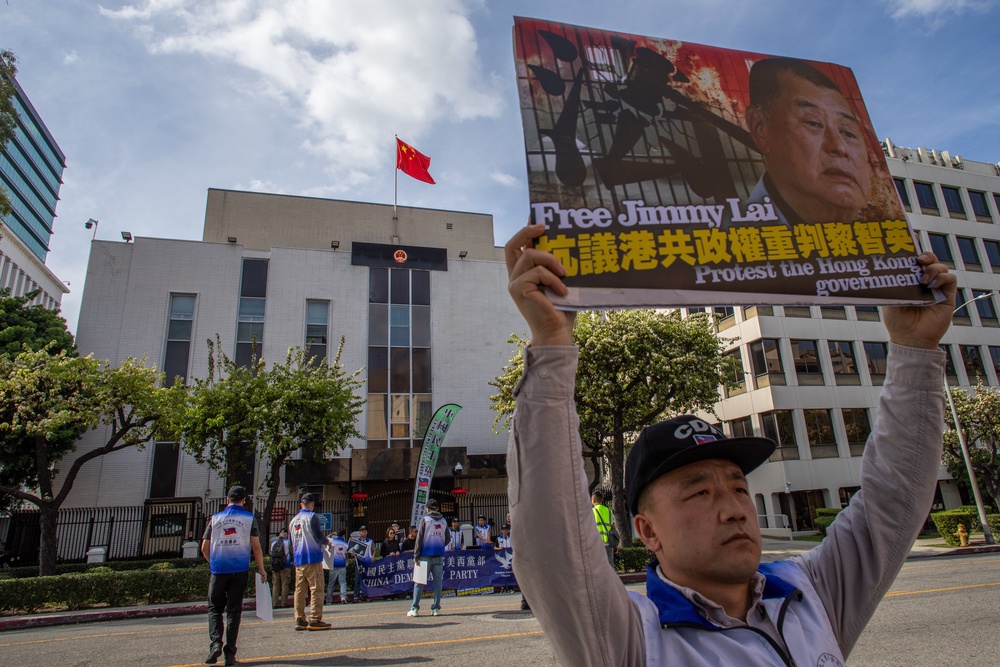 People gather in front of the Chinese Consulate General in LA to protest the unjust conviction of media entrepreneur Jimmy Lai (Getty)