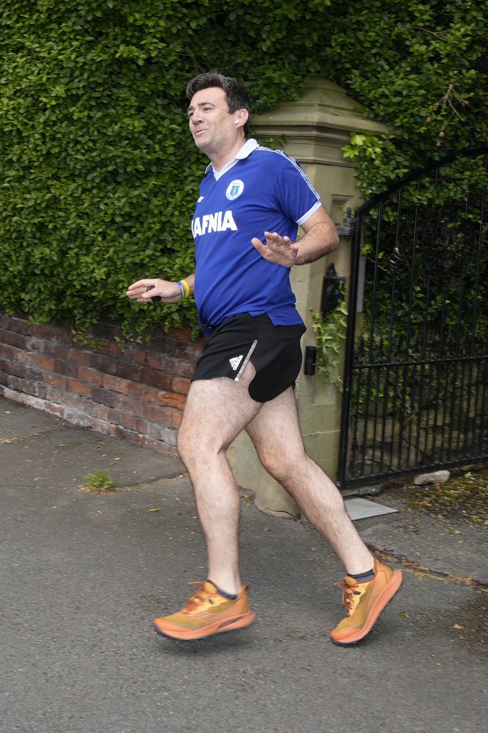 Mayor of Greater Manchester Andy Burnham running outside his house in Warrington, Cheshire, on Friday (PA)